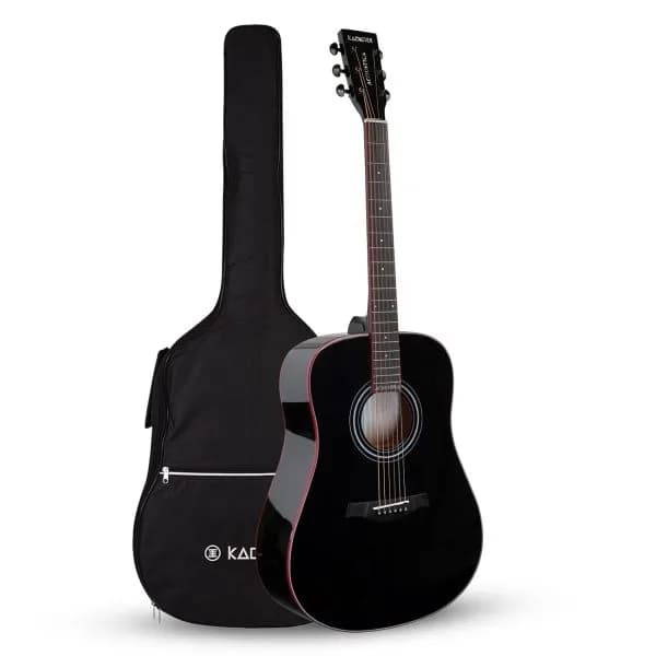A black Kadence dreadnought acoustic guitar standing beside its black padded gig bag