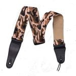 A camo print guitar strap with black leather ends
