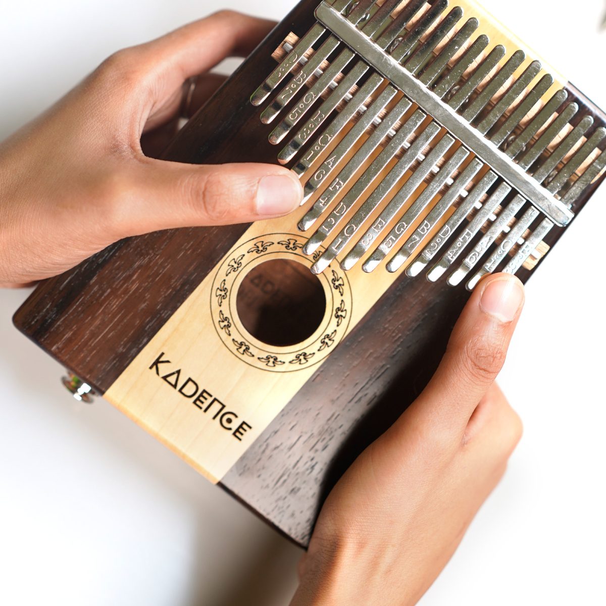 A person holding kadece kalimba with two hands